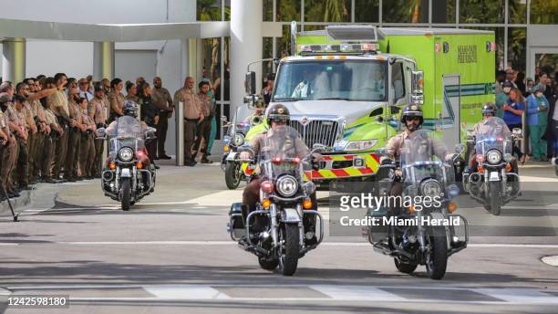 Police escort the body of Miami-Dade Police Detective Cesar Echaverry from Jackson Memorial Hospital to the Miami-Dade County Medical Examinerâs...