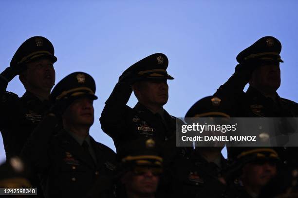 Police officers salute Colombian President Gustavo Petro during a ceremony to appoint General Henry Sanabria as Police Director at the General...