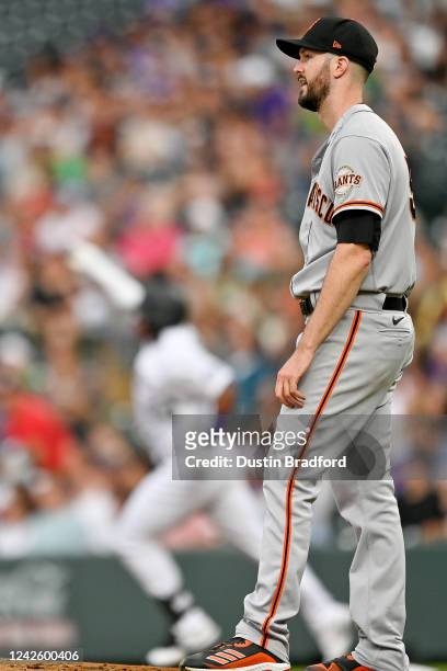 Alex Wood of the San Francisco Giants reacts after allowing a second inning home run to Elehuris Montero of the Colorado Rockies during a game at...