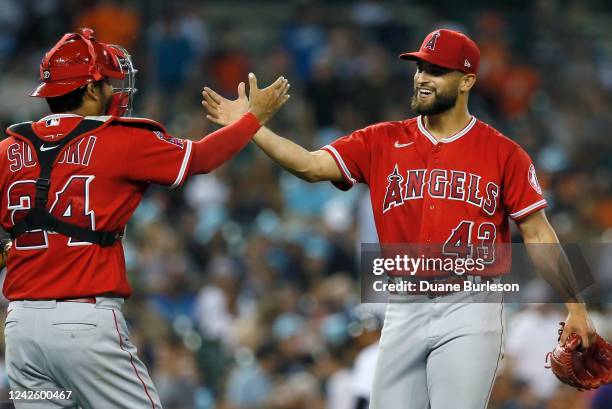 Starting pitcher Patrick Sandoval of the Los Angeles Angels celebrates with catcher Kurt Suzuki after pitching a four-hitter complete game against...