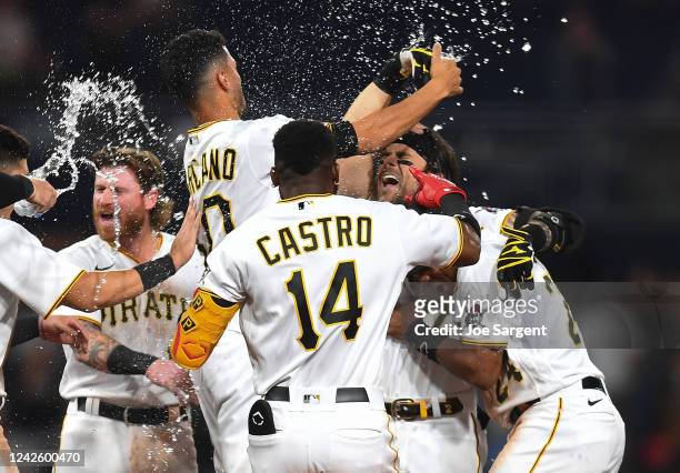 Michael Chavis of the Pittsburgh Pirates celebrates his game winning single with teammates during the ninth inning against the Cincinnati Reds at PNC...