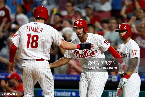 Bradley Zimmer of the Philadelphia Phillies is congratulated by Matt Vierling of the Philadelphia Phillies after scoring on a two-run single by Kyle...