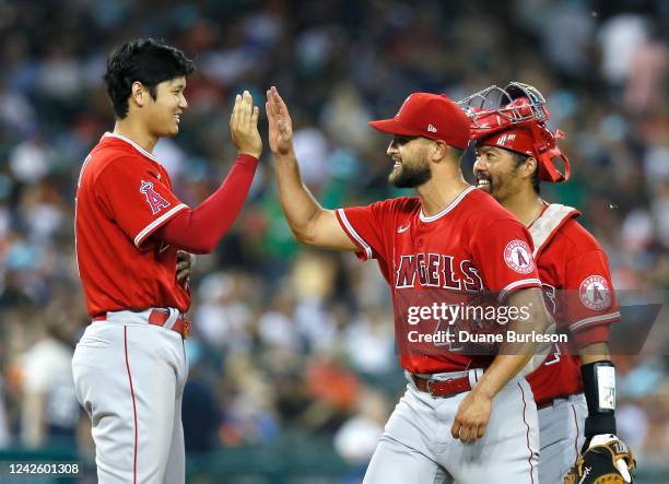 Shohei Ohtani of the Los Angeles Angels celebrates with pitcher Patrick Sandoval and catcher Kurt Suzuki after Sandoval pitched a four-hit complete...