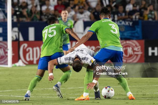 Danny Leyva and Xavier Arreaga of Seattle Sounders sandwich Javier Hernández of Los Angeles Galaxy during the match at the Dignity Health Sports Park...