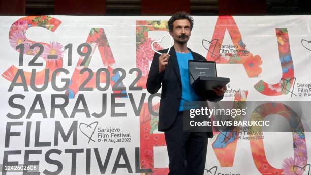 Croatian film director and actor Juraj Lerotic shows his award "Heart of Sarajevo" for best lead role in the movie "The Safe Place", on the final...