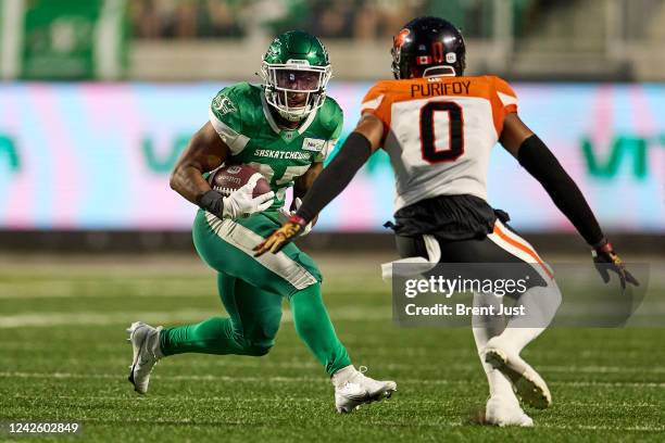 Jamal Morrow of the Saskatchewan Roughriders looks to avoid Loucheiz Purifoy of the BC Lions on a run in the game between the BC Lions and...