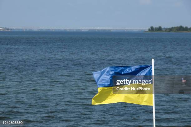 Ukrainian flag against the background of the Dnipro River near Cherkasy, Ukraine, August 19, 2022