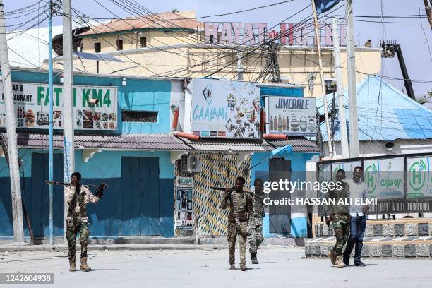Security officers patrol near the the site of explosions in Mogadishu on August 20, 2022. - At least eight civilians have been killed in an Islamist...
