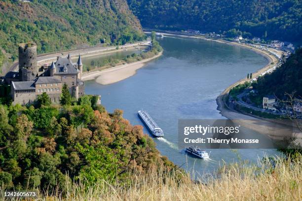 The Inland Tanker 'Panera' and the Passenger ship 'RheinKrone' are sailing between the dry banks of the Rhine river on August 16 in Sankt Goar,...