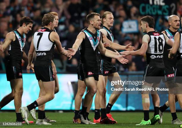 Robbie Gray of the Power celebrates a goal with team mates during the 2022 AFL Round 23 match between the Port Adelaide Power and the Adelaide Crows...