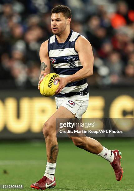 Brandan Parfitt of the Cats runs with the ball during the round 23 AFL match between the Geelong Cats and the West Coast Eagles at GMHBA Stadium on...