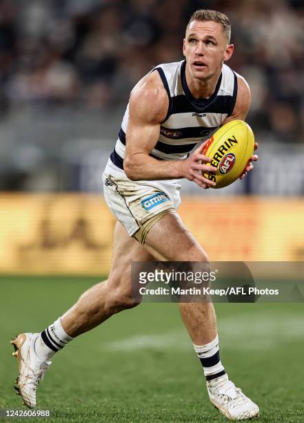 Joel Selwood of the Cats runs with the ball during the round 23 AFL match between the Geelong Cats and the West Coast Eagles at GMHBA Stadium on...