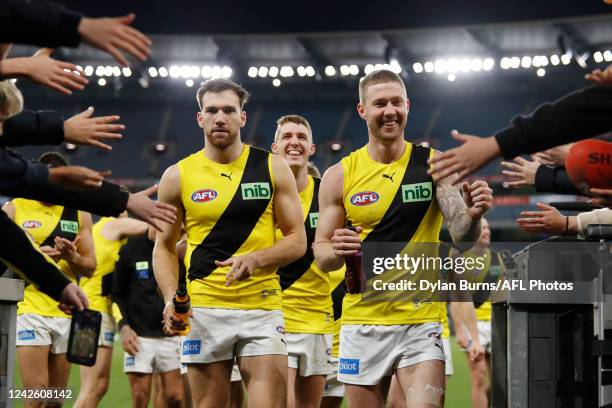 Nathan Broad and Noah Balta of the Tigers leave the field during the 2022 AFL Round 23 match between the Essendon Bombers and the Richmond Tigers at...