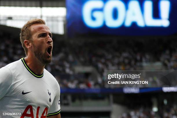 Tottenham Hotspur's English striker Harry Kane celebrates as he scores the first goal during the English Premier League football match between...