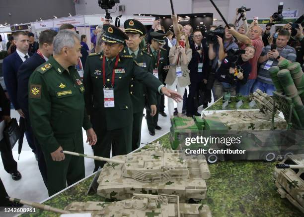 Russian Defence Minister Sergei Shoigu , followed by a Chinese officer, looks to the models of Chinese tanks while visiting the Chinese military...