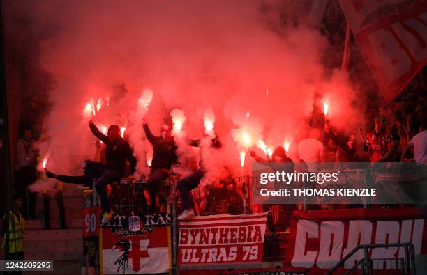 Freiburg fans burn flares at the start of the German first division Bundesliga football match VfB Stuttgart v SC Freiburg in Stuttgart, southern...