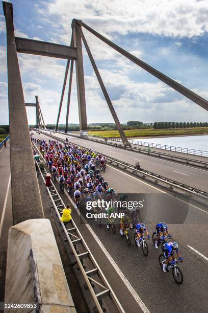 Atmospheric image of the peloton that passes the Waal over the Prince Willem Alexander Bridge near Ooij during the second stage of the Tour of Spain...