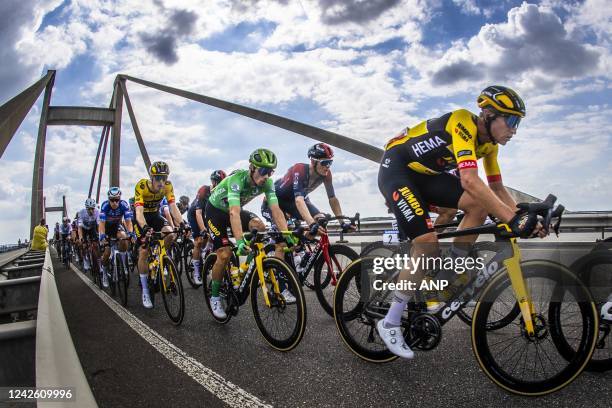 Atmospheric image of Rohan Dennis, Primoz Roglic, Edoardo Affini of the Jumbo Visma team in the lead of the peloton that passes the Waal over the...