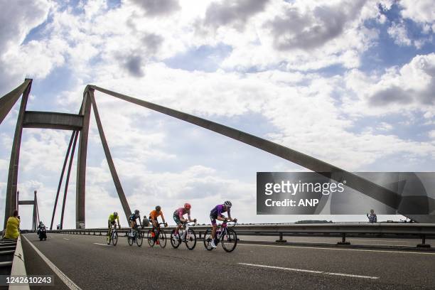 Atmosphere of the leading group with the peloton shortly behind that passes the Waal over the Prince Willem Alexander Bridge near Ooij during the...