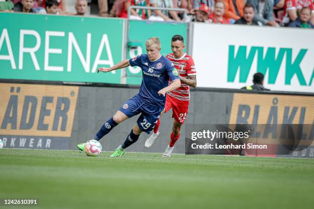 Jonathan Burkardt of Mainz and Iago Amaral Borduchi of Augsburg during the Bundesliga match between FC Augsburg and 1. FSV Mainz 05 at WWK-Arena on...