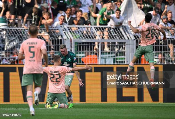 Bremen's German midfielder Niklas Schmidt celebrates with team mates his 2-2 during the German first division Bundesliga football match between...