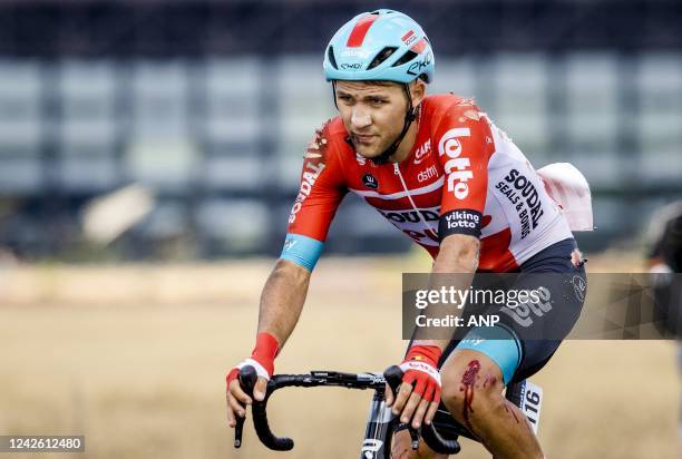 An injured Kamil Malecki of team Lotto Soudal passes the runway of Soesterberg airbase during the second stage of the Vuelta a Espana . The second...