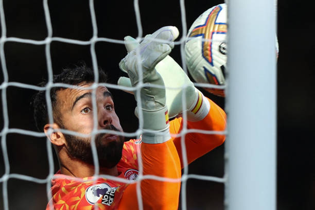 Brentford's Spanish goalkeeper David Raya saves a shot during the English Premier League football match between Fulham and Brentford at Craven...