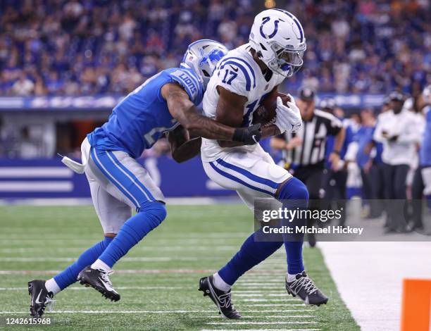 Mike Strachan of Indianapolis Colts runs the ball as Mark Gilbert of Detroit Lions makes the tackle during the first half at Lucas Oil Stadium on...