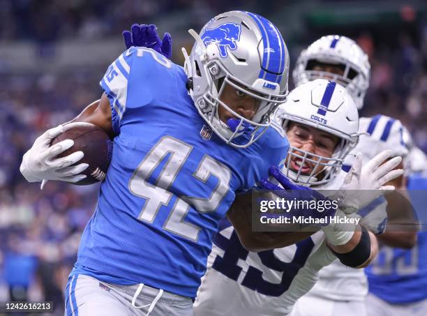 Justin Jackson of Detroit Lions runs the ball after the catch as Forrest Rhyne of Indianapolis Colts hangs on for the stop during the first half at...