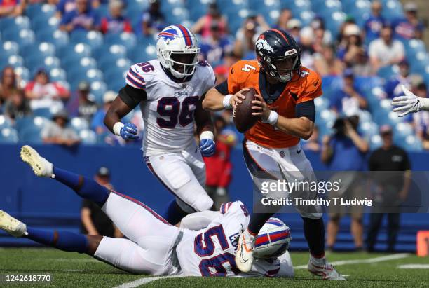 Mike Love of the Buffalo Bills misses a tackle on Brett Rypien of the Denver Broncos as he looks to throw a pass during the second half of a...