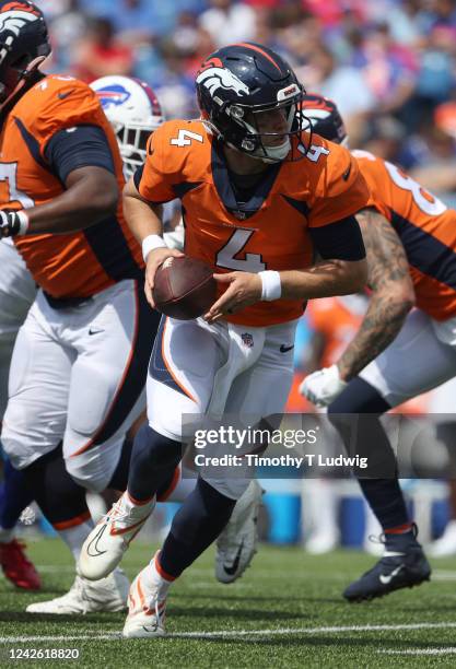 Brett Rypien of the Denver Broncos looks to hand the ball of during the second half of a preseason game against the Buffalo Bills at Highmark Stadium...
