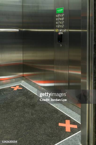 social distancing markers inside the elevators - social distancing elevator stock pictures, royalty-free photos & images