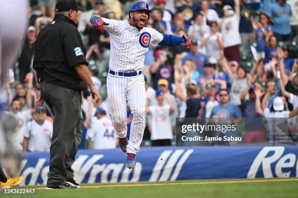 Willson Contreras of the Chicago Cubs celebrates after hitting a walk-off single in the 11th inning against the Milwaukee Brewers at Wrigley Field on...
