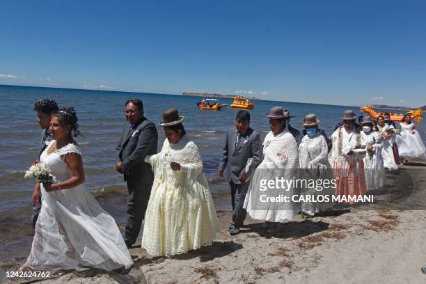Couples are seen during a mass wedding ceremony where fifty couples got married at the shore of lake Titicaca in the Aymara district of Acora in...
