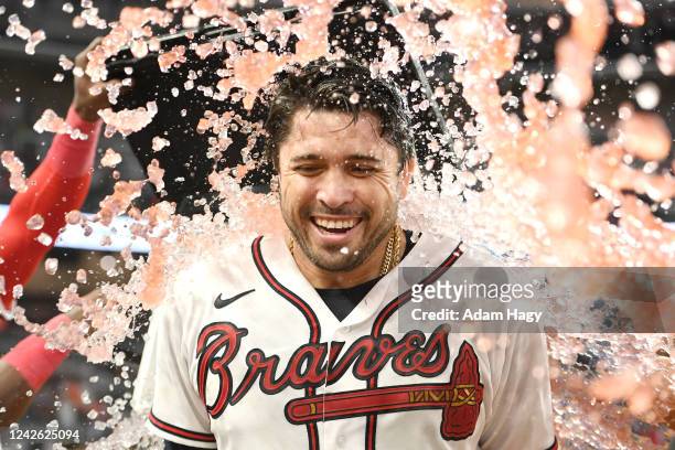 Travis d'Arnaud of the Atlanta Braves gets a Gatorade bath by teammates after hitting a walk off single against the Houston Astros during the...