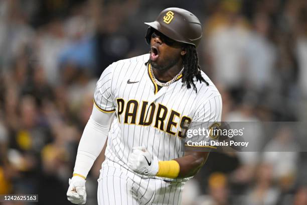Josh Bell of the San Diego Padres reacts after hitting a solo home run during the fifth inning of a baseball game against the Washington Nationals...