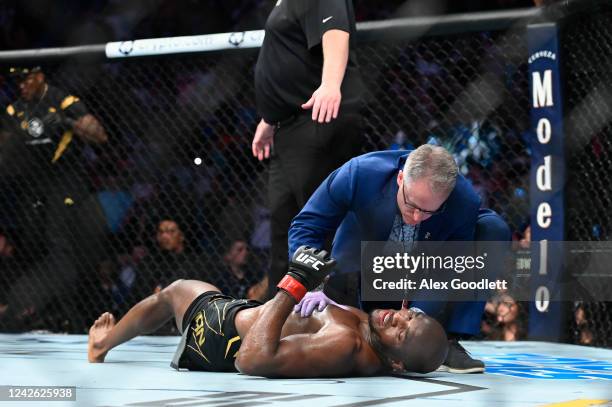 Kamaru Usman of Nigeria lays on the mat after being knocked out by Leon Edwards of Jamaica in a welterweight title bout during UFC 278 at Vivint...