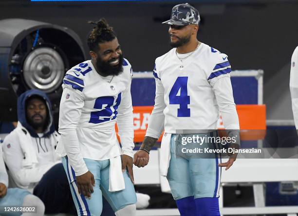 Ezekiel Elliott of the Dallas Cowboys and quarterback Dak Prescott on the sideline during the second half of a preseason game against the Los Angeles...