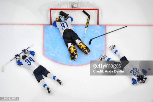 Aatu Raty, Juha Jatkola and Roni Hirvonen of Finland lay on the ice after losing the gold medal game against Canada in the IIHF World Junior...