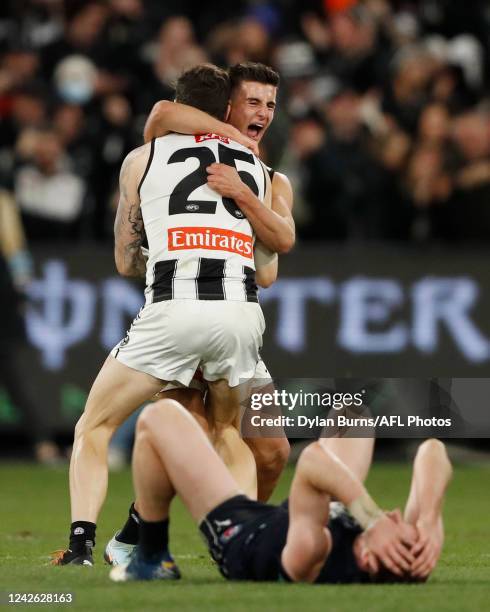 Nick Daicos of the Magpies and Jack Crisp of the Magpies celebrate during the 2022 AFL Round 23 match between the Carlton Blues and the Collingwood...