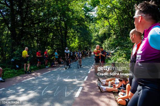 People are seen waiting for the peloton to pass by. The peloton set off from s-Hertogenbosch with 182 riders and many attackers willing to make the...