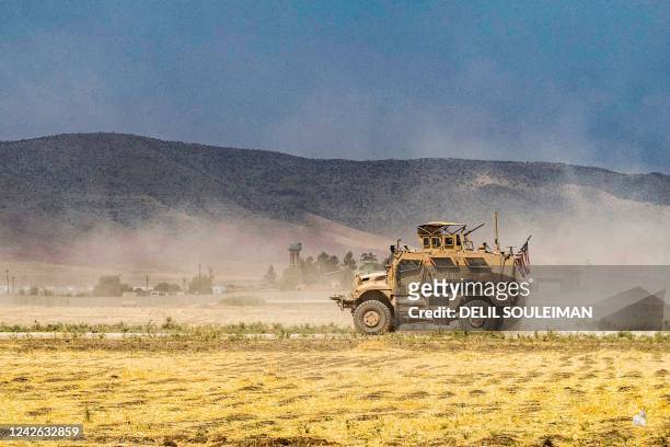 An US Oshkosh M-ATV Mine Resistant Ambush Protected military vehicle drives during a patrol near the Syrian-Turkish border in one of the villages...