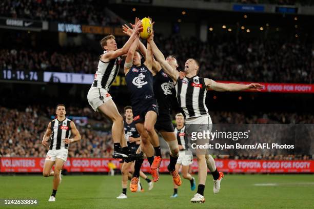 Will Hoskin-Elliott of the Magpies, Corey Durdin of the Blues, Marc Pittonet of the Blues and Darcy Cameron of the Magpies compete for the ball...
