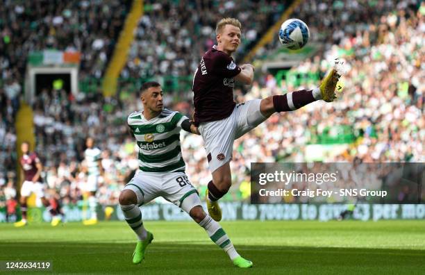 Celtic's Josip Juranovic and Hearts' Gary Mackay-Steven in action during a cinch Premiership match between Celtic and Hearts at Celtic Park, on...