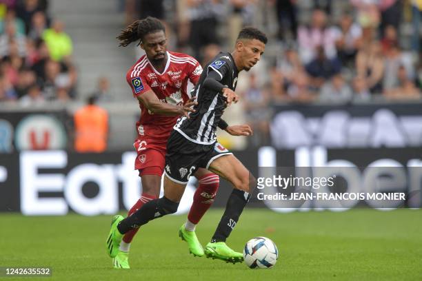 Brest's French defender Jean-Kevin Duverne fights for the ball with Angers' Moroccan midfielder Azzedine Ounahi during the French L1 football match...