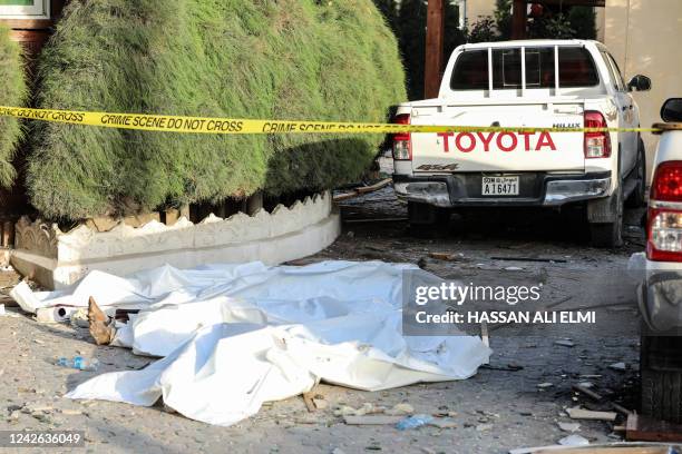 Graphic content / The bodies of the alleged attackers are seen on the ground inside the compound of the Hayat Hotel in Mogadishu on August 21, 2022....