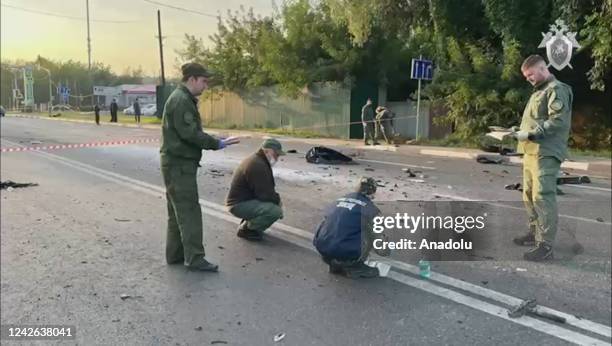 Russian officials investigate the scene after the car of Darya Dugina, daughter of Alexander Dugin, Russian political scientist and ally of President...