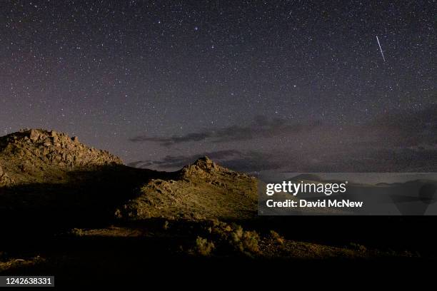 Meteor steaks across the sky over the Alabama Hills, near the eastern Sierras, during the annual Perseid meteor shower on August 20, 2022 near Lone...