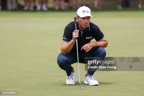 Mike Weir of Canada lines up a putt on the first green during the final round of the DICK'S Sporting Goods Open at En-Joie Golf Club on August 21,...