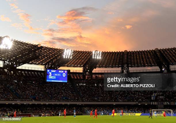 The sun sets over the Diego-Maradona stadium in Naples as the scoreboard displays 3-0 after Napoli's Georgian forward Khvicha Kvaratskhelia scored...